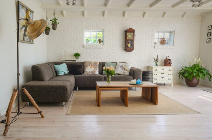 Bown wooden centre table with chase lounge and exposed beams in a cute interior designed living room